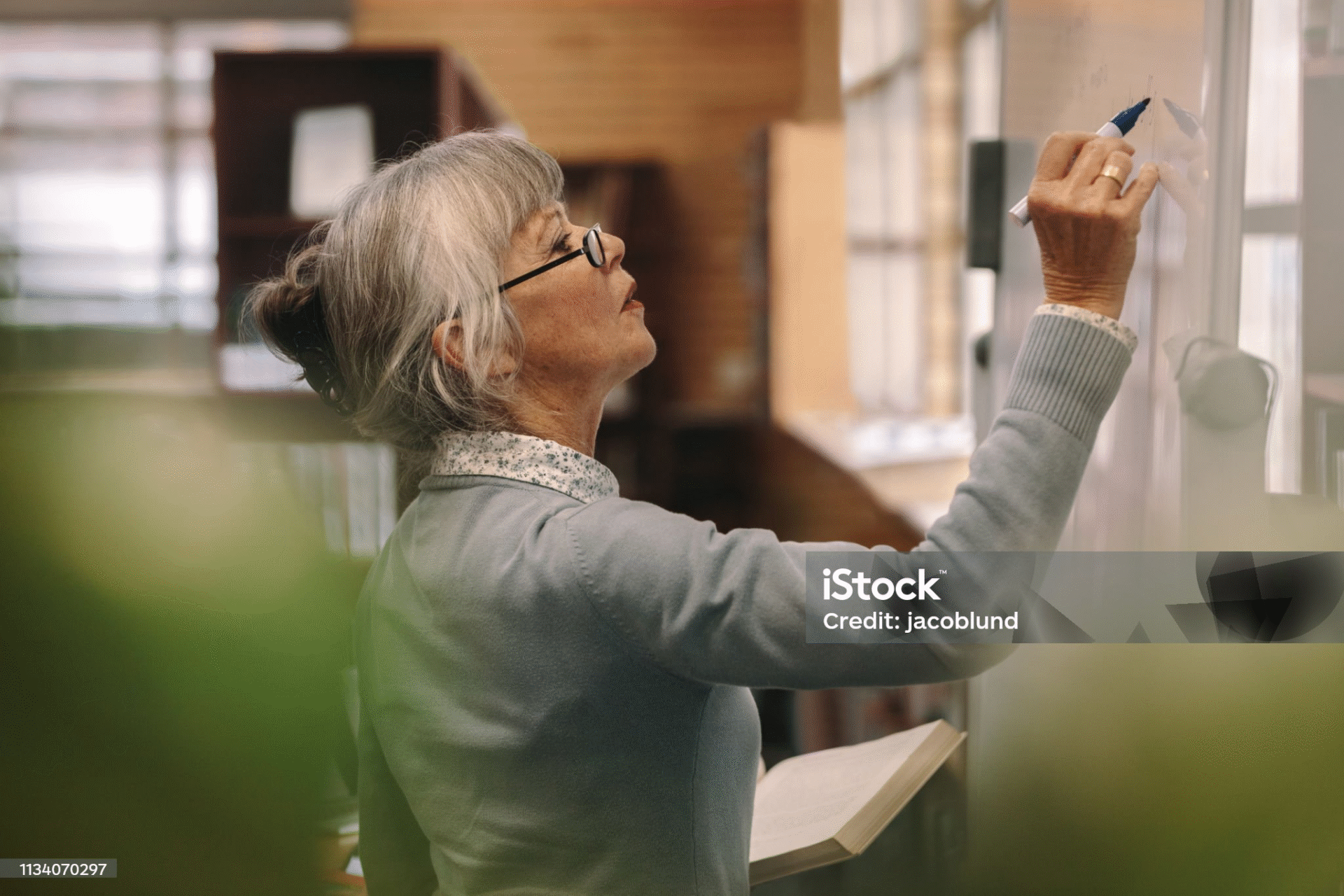 Woman writing on a whiteboard