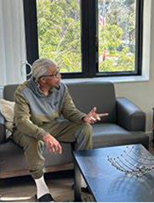 Image of a man sitting on a couch