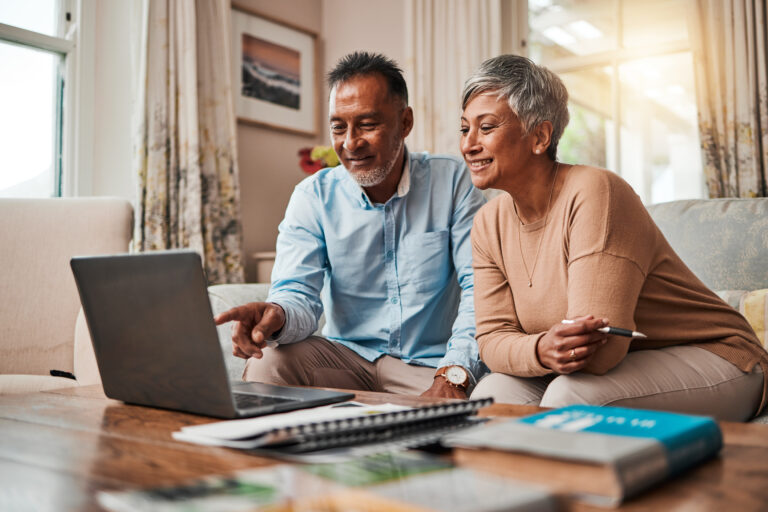 Picture of a middle-aged couple looking at a computer screen
