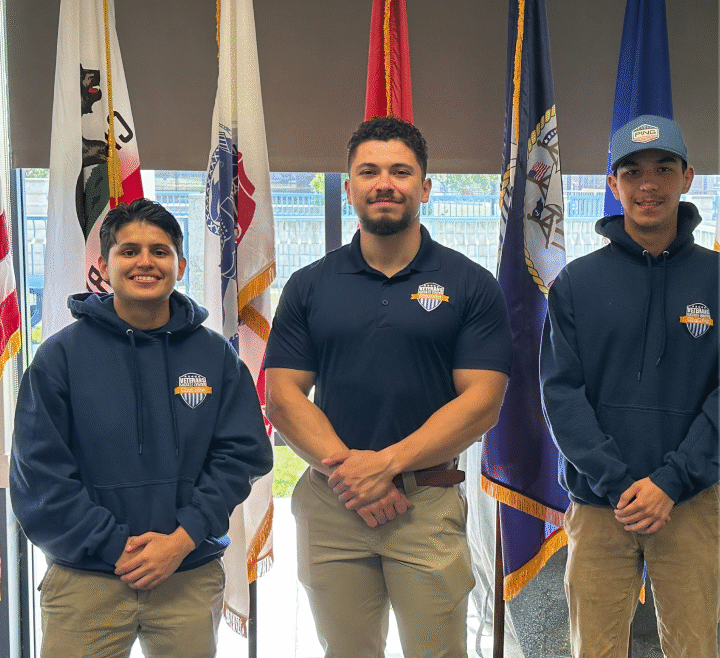 Group of people standing in front of a flag