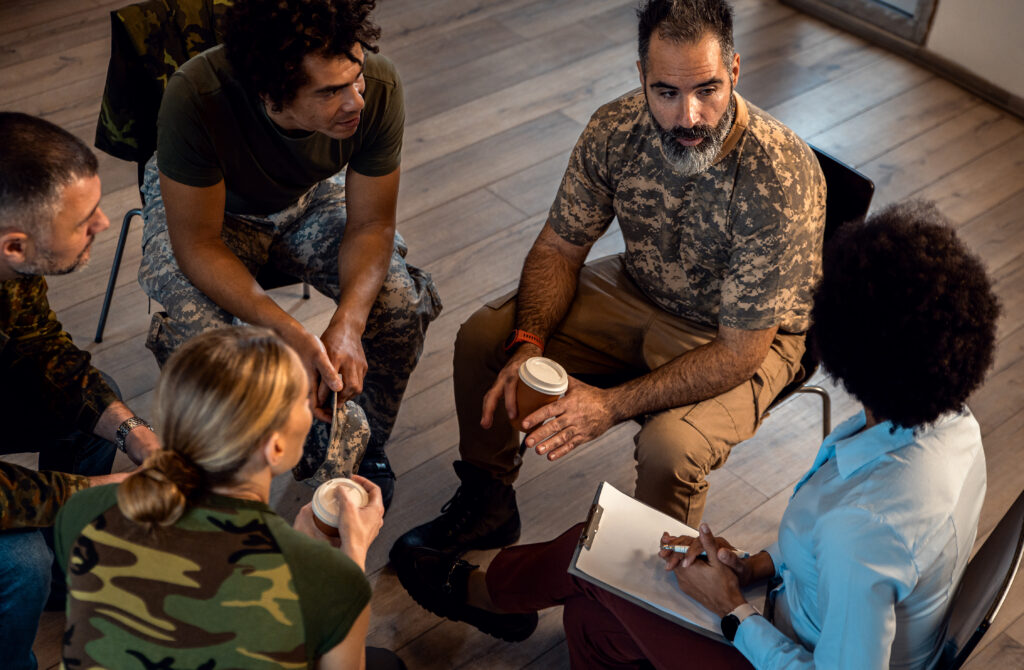 Group of veterans, sitting in a circle, talking
