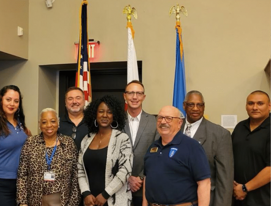 Group of people standing in front of a flag