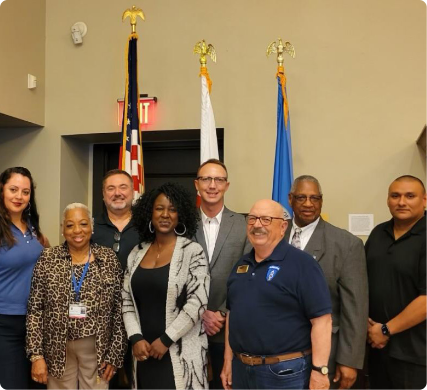 Group of people standing in front of a flag