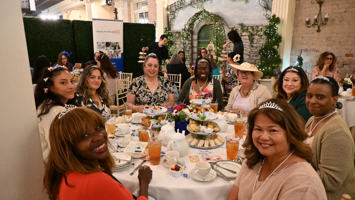 Women veterans seated around a tea table enjoy refreshments and conversation during the Women Veteran Tea Party at the Tea Rose Garden in Pasadena.